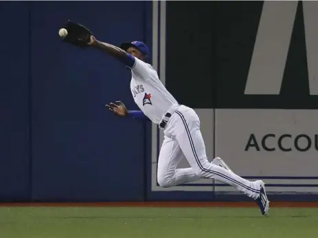  ?? RICHARD LAUTENS/TORONTO STAR ?? Jays outfielder Melvin Upton Jr. stretches to take a hit away from Tampa Bay’s Nick Franklin in the fifth inning. The Rays scored three runs in the inning.