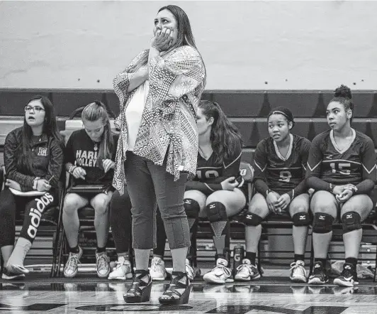  ?? Photos by Josie Norris / Staff photograph­er ?? From the sidelines, Harlan coach Monica Gonzales nervously watches her team on the court as it takes on MacArthur at Paul Taylor Field House.