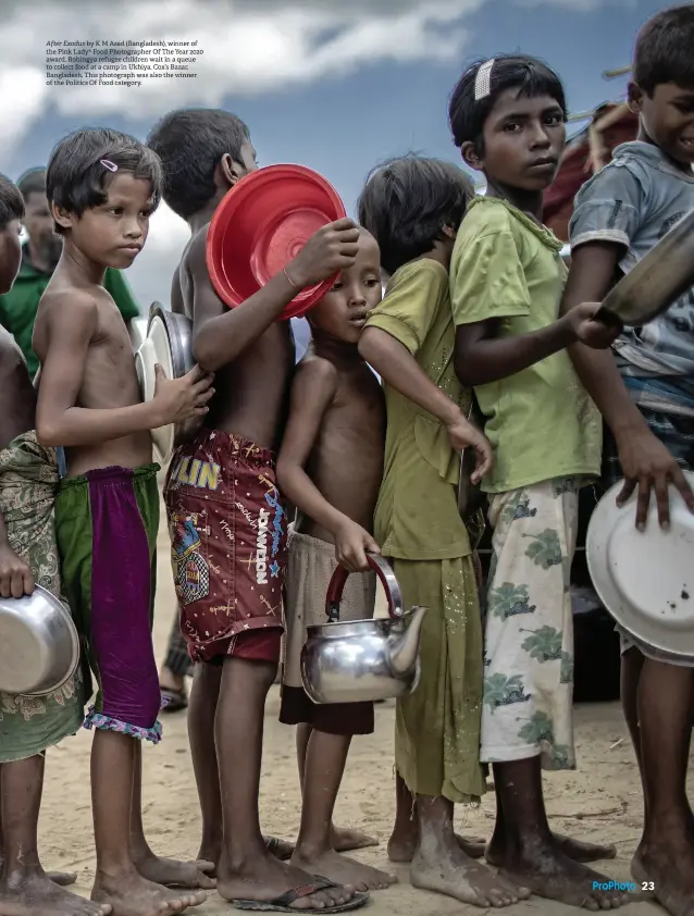  ??  ?? After Exodus by K M Asad (Bangladesh), winner of the Pink Lady® Food Photograph­er Of The Year 2020 award. Rohingya refugee children wait in a queue to collect food at a camp in Ukhiya, Cox’s Bazar, Bangladesh. This photograph was also the winner of the Politics Of Food category.