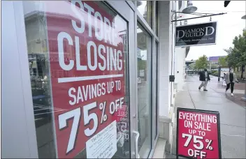  ?? STEVEN SENNE — THE ASSOCIATED PRESS FILE ?? Passers-bywalk past a business storefront with store closing and sale signs in Dedham, Mass., on Sept. 2.
