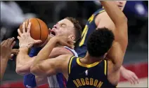  ??  ?? Griffin is fouled next to Indiana Pacers guard Malcolm Brogdon (7) during the second half of a Feb. 11 game in Detroit.