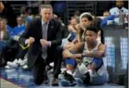  ?? CHRIS SZAGOLA — THE ASSOCIATED PRESS ?? Sixers coach Brett Brown, left, talks with Markelle Fultz during the first half of Game 1 against the Miami Heat Saturday. By the middle of the first half of Game 2 Monday night, Fultz was doing his sitting on the bench.