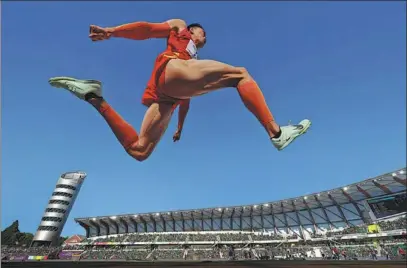  ?? AFP ?? Zhu Yaming of Team China soars through the air during the men’s triple jump final at the World Athletics Championsh­ips in Eugene, Oregon, on Saturday. Olympic silver medalist Zhu took bronze (17.31m) behind Olympic champion Pedro Pichardo of Portugal (17.95m) and Olympic bronze medalist Hugues Fabrice Zango of Burkina Faso (17.55m).