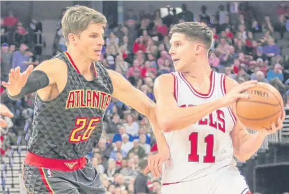 ?? | NATI HARNIK/ AP ?? Doug McDermott, guarded by the Hawks’ Kyle Korver on Thursday, is the Bulls’ best outside shooter. Given their struggles shooting, they’ll need him to deliver.