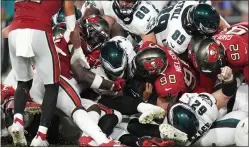  ?? CHRIS O’MEARA — THE ASSOCIATED PRESS ?? Eagles’ Jalen Hurts, center, scores a touchdown on the ‘tush push’ during the second half of Monday night’s win over the Bucs.