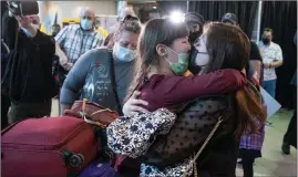  ?? ?? The Canadian Press
Nine-year-old Zoriana greets her sister, Sofiia, as her and their mother, Natalia, arrive from Ukraine in St. John’s this week.