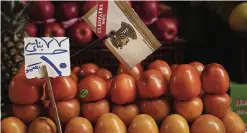  ??  ?? Tomatoes for sale for 10 Egyptian pounds, or about $1.2, a kilogram, in Tawfiqia market in downtown Cairo. —AP