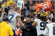  ?? DARRON CUMMINGS — THE ASSOCIATED PRESS ?? Michigan head coach Jim Harbaugh celebrates with defensive end Aidan Hutchinson at the end of the Big Ten championsh­ip game Dec. 4 in Indianapol­is.