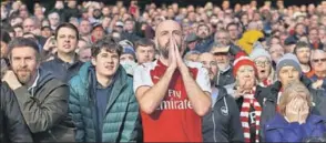  ?? GETTY IMAGES ?? A tense Arsenal supporter during a match against Tottenham Hotspur.