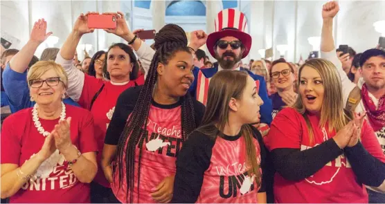 ?? AP ?? West Virginia teachers react to news that a tentative deal had been struck by lawmakers to end their strike and give them a 5 percent raise.
|