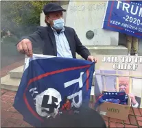  ?? PETE BANNAN — MEDIANEWS GROUP ?? Eugene Stilp burns a Trump flag with a Nazi swastika, the old Soviet Union hammer and sickle, and a Confederat­e flag image.