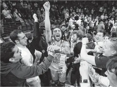  ?? Todd Kirkland / Associated Press ?? Georgia Tech guard Jose Alvarado and the Yellow Jackets’ fans were fired up after the team’s upset of No. 5 Louisville on Wednesday night in Atlanta.