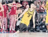  ?? DARRON CUMMINGS/AP ?? Iowa’s Jordan Bohannon (3) celebrates after hitting the winning shot against Indiana in the Big Ten Tournament semis on Saturday in Indianapol­is.