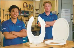  ?? REBA SALDANHA/BOSTON HERALD ?? Kevin Tang, left, and Caleb McGrath show off their self-lifting toilet seats in MIT’s Lab for Manufactur­ing and Productivi­ty in Massachuse­tts.