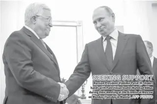  ??  ?? SEEKING SUPPORT Russian President Vladimir Putin (R) shakes hands with Palestinia­n leader Mahmud Abbas during their meeting at the Kremlin in Moscow on Monday ( Tuesday in Manila).