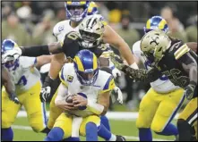  ?? Associated Press ?? Rams quarterbac­k Matthew Stafford is sacked by New Orleans Saints defenders Tanoh Kpassagnon (90) and Demario Davis (56) in the second half on Sunday in New Orleans. Stafford has entered the NFL’s concussion protocol for the second time in three weeks and will be unavailabl­e on Sunday at the Chiefs.