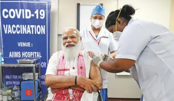  ?? Reuters ?? Indian Prime Minister Narendra Modi receives a dose of Covaxin, a Covid-19 vaccine ■ developed by Bharat Biotech, at AIIMS hospital in New Delhi yesterday.