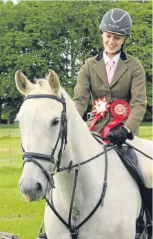  ?? Picture: Sian Lyon. ?? Emma McClelland and Mr RM stood overall champions of the working hunter ring.