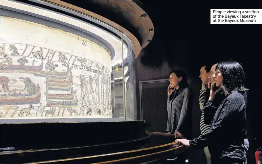  ??  ?? People viewing a section of the Bayeux Tapestry at the Bayeux Museum