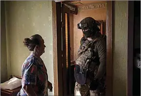  ?? ?? A Security Service of Ukraine serviceman talks to a woman during an operation to arrest suspected Russian collaborat­ors in Kharkiv, Ukraine, April 14.