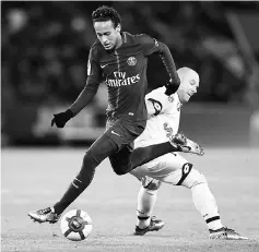  ??  ?? Neymar snatches the ball from Dijon’s Florent Balmont during the French Ligue 1 match between Paris Saint-Germain and Dijon at the Parc des Princes stadium in Paris. — AFP photo