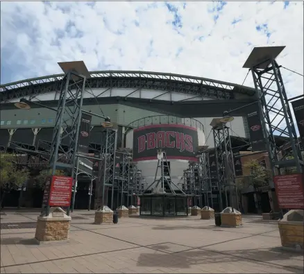  ?? ROSS D. FRANKLIN ?? The main entrance in front of Chase Field is devoid of activity in Phoenix. Putting all 30 teams in the Phoenix area this season and playing in empty ballparks was among the ideas discussed Monday, April 6, 2020 during a call among five top officials from MLB and the players’ associatio­n that was led by Commission­er Rob Manfred, people familiar with the discussion told The Associated Press.