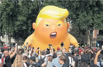  ?? MATT DUNHAM/THE ASSOCIATED PRESS ?? A six-metre high cartoon baby blimp of U.S. President Donald Trump is flown as a protest against his visit to London, England.