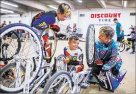  ?? Patrick Connolly ?? Las Vegas Review-journal @Pconnpie Troy Griffin, 11, from left, Reese Griffin, 7, and Tyler Cowell, 11, of Gilroy, Calif., hang out in between races at the USA BMX 2017 Las Vegas Nationals on Sunday.