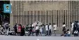  ?? | BONGANI MBATHA Independen­t Newspapers. ?? PEOPLE queuing outside the Greyville post office in Durban to collect their unemployme­nt grant.