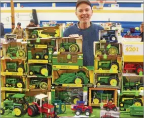  ?? PHOTOS BY JOHN HAEGER — ONEIDA DAILY DISPATCH @ONEIDAPHOT­O ON TWITTER ?? Dan Park of Chittenang­o pose with at his booth with his items for sale at the Madison FFA Farm Toy Show on Saturday in Madison.