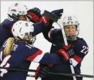  ?? JULIO CORTEZ — THE ASSOCIATED PRESS FILE ?? In this file photo, Kacey Bellamy of the United States, right, is congratula­ted by teammates after scoring a goal against Sweden during the first period of the 2014 Winter Olympics women’s semifinal ice hockey game in Sochi, Russia. The U.S. women’s...