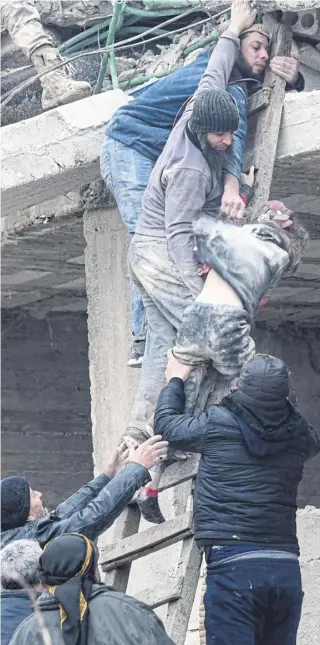  ?? ?? ↑ A girl is brought to safety from the rubble of a collapsed building in Jandaris, near the Syrian city of Afrin in the rebel-held part of Aleppo province. The death toll in the northweste­rn province was said to be at least 380, with hundreds more injured