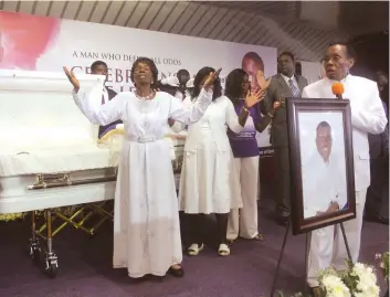  ?? Picture: ?? ZAOGA church founder Apostle Ezekiel Guti, his wife Dr Eunor Guti and their daughter-in-law Pastor Caroline Guti in worship at Ezekiel Jnr’s memorial service in Harare yesterday. Also see The Sunday Mail Society Innocent Makawa