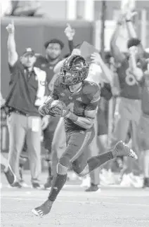  ?? MICHAEL LAUGHLIN/SUN SENTINEL ?? Miami running back Jaylan Knighton runs for the end zone against North Carolina State on Saturday.