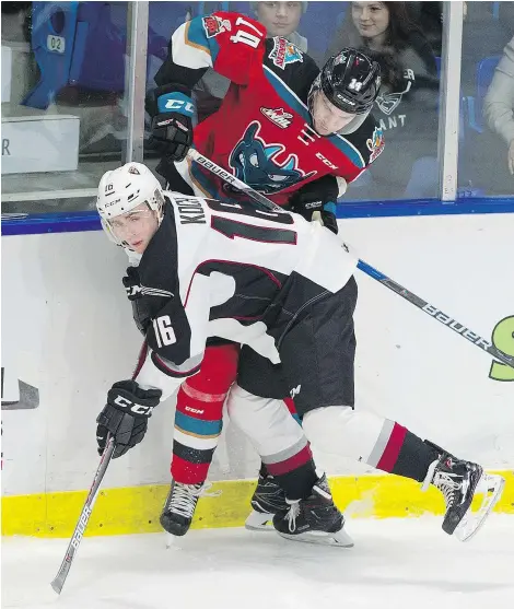  ?? GERRY KAHRMANN/PNG ?? Davis Koch was wearing Vancouver Giants white and black Saturday against Wil Kushniryk and the Kelowna Rockets. The 19-year-old forward says his transition to the team is coming along just fine.