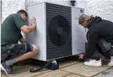  ?? ?? Strategy...engineers fitting a heat pump