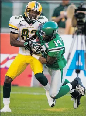  ?? Handout ?? Jason Tucker, left, seen playing for the Edmonton Eskimos in 2008, now coaches for the Roughrider­s after suffering a broken neck during a helmet-to-helmet collision.