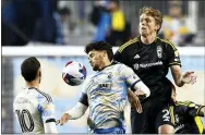  ?? RICH SCHULTZ - AP ?? Philadelph­ia Union forward Julian Carranza (9) heads the ball away from Columbus Crew defender Perry Kitchen (2) during an MLS match, Saturday, Feb. 25, in Chester.