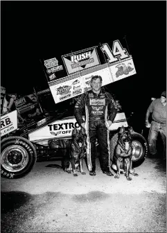  ??  ?? Stewart at the track, with his dogs Mia and Max