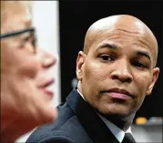  ?? BEN GRAY / FOR THE AJC ?? U.S. Surgeon General Jerome Adams listens to Dr. Kathleen E. Toomey, commission­er of the Georgia Department of Public Health, at a Friday afternoon news conference about coronaviru­s.