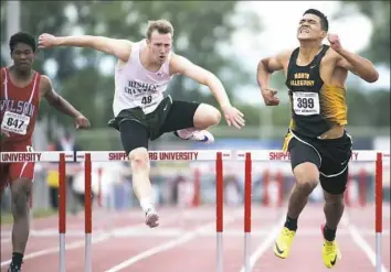  ??  ?? North Allegheny’s Ayden Owens, right, wins the 300-meter hurdles.