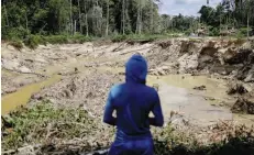  ?? — Reuters file photo ?? An illegal miner looks at a destroyed forest area in Yanomami Indigenous Land, Roraima state, Brazil.