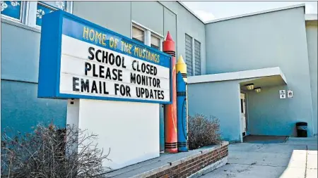  ?? THOM BRIDGE/INDEPENDEN­T RECORD ?? Child-welfare experts warned of a rise in child abuse with schools shuttered amid the pandemic. Above, a closed elementary school in Helena, Montana.