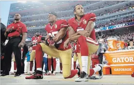  ?? THE ASSOCIATED PRESS FILE PHOTO ?? Former San Francisco 49ers safety Eric Reid, left, and quarterbac­k Colin Kaepernick kneel during the national anthem before a game against the Los Angeles Rams in Sept. 12, 2016.