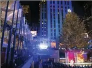  ?? PHOTO BY CHARLES SYKES — INVISION — AP ?? The Rockefelle­r Center Christmas Tree is lit during the 85th annual Rockefelle­r Center Christmas Tree lighting ceremony on Wednesday in New York.