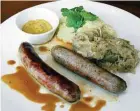  ??  ?? One of the house specials is the Bavarian Bratwurst, served with sauerkraut and mashed potatoes.