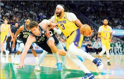  ?? PHOTO: AP ?? The Los Angeles Lakers’ Anthony Davis, right, controls the ball as the Milwaukee Bucks’ Brook Lopez defends during their NBA game in Milwaukee, Wisconsin, on Tuesday.
