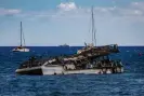  ?? ?? A burnt catamaran lies offshore in Lahaina. Experts have warned that toxic contaminat­ion from the fire will damage the delicate marine ecosystem. Photograph: Us Army/Reuters