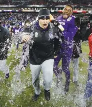  ??  ?? Northweste­rn coach Pat Fitzgerald is doused after Northweste­rn beat Kentucky 24-23 in the Music City Bowl on Friday in Nashville.