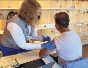  ?? Gov. Ned Lamont’s Office / Contribute­d photo ?? Gov. Ned Lamont receiving a COVID-19 vaccine booster shot at the Durham Fair on Saturday.